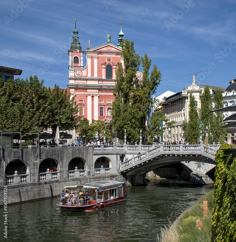 View of pink church in downtown Ljubljana, Slovenia, Europe from the river downtown. photo