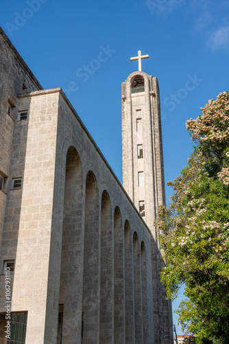 Neo-Romanesque style church with a bell tower ending in a cross in the Miramar neighborhood of the Cuban capital. photo