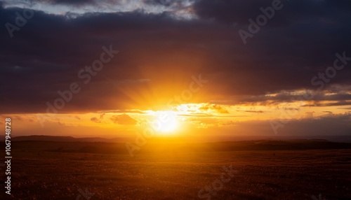 A big sun rises under the dark sky