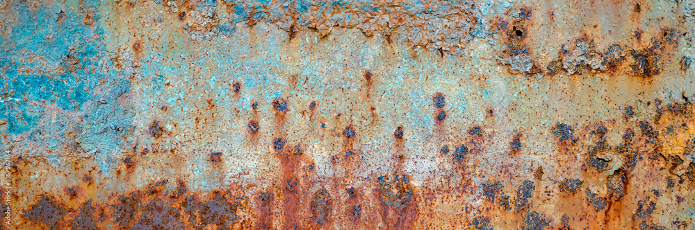 Close-up of a rusty metal surface featuring blue peeling paint, corrosion patterns, and textured decay. Close-up of a rusty metal surface featuring blue peeling paint, corrosion patterns, and textured decay.