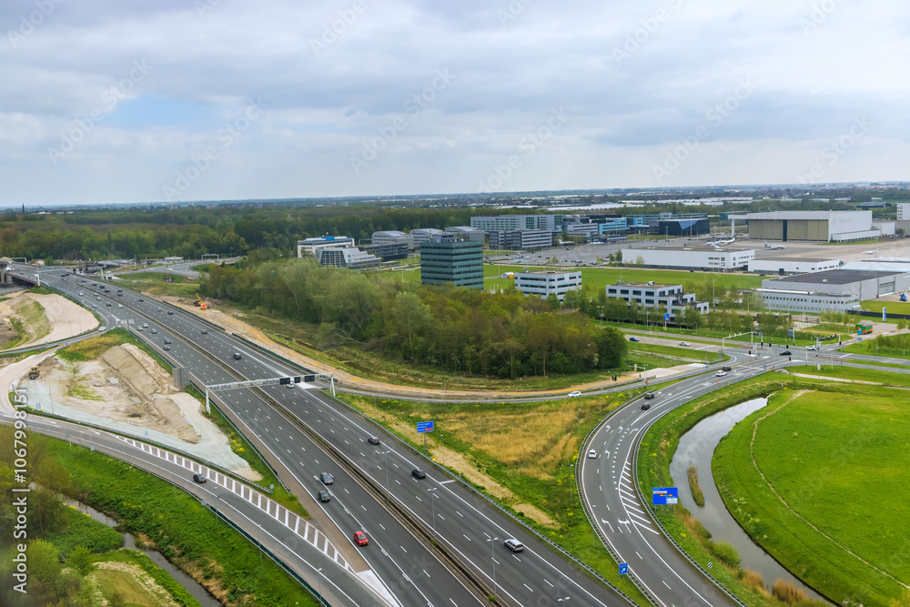 Naklejka premium An aerial view of Amsterdam, Netherlands, showing rooftops in cloudy weather
