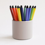colorful markers in grey cup on white background