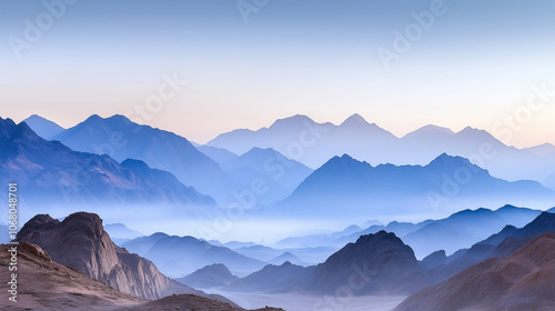 a misty mountain range with layers of peaks fading into the distance