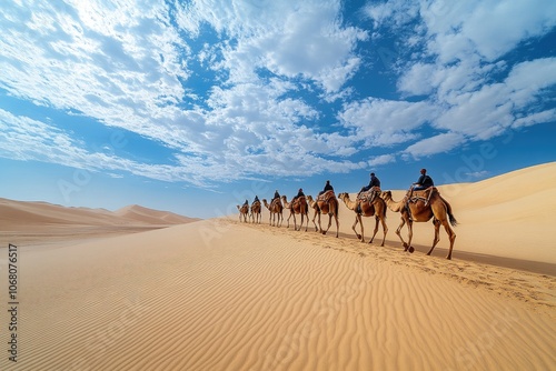 Tourists riding camels in desert landscape under cloudy sky