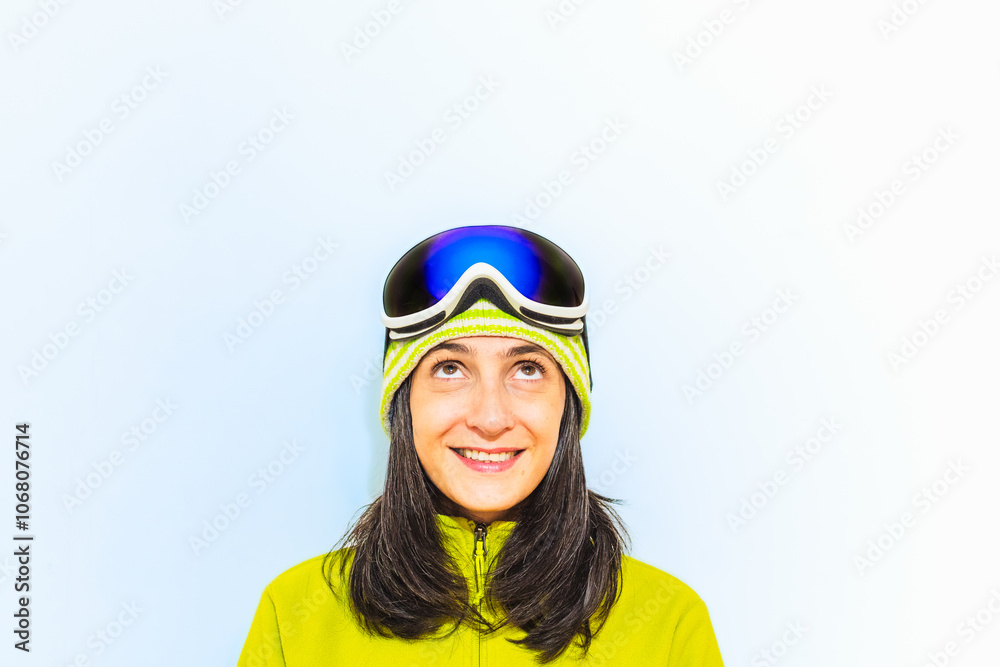 Close up snowboarder happy woman 20s wear blue suit goggles mask hat ski looking up to empty white copy space. Winter ski holidays travel banner weekend trip template Winter sport hobby trip outdoors Close up snowboarder happy woman 20s wear blue suit goggles mask hat ski looking up to empty white copy space. Winter ski holidays travel banner weekend trip template Winter sport hobby trip outdoors