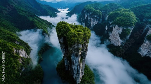 Aerial view of towering cliffs surrounded by mist and lush vegetation. photo