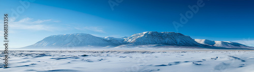 Snowcapped mountains under a clear blue sky, winter weather, cold and majestic