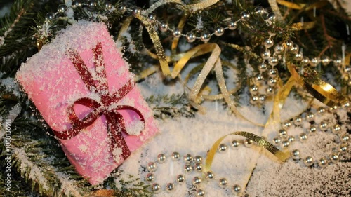 Christmas background with green spruce, gift and candy on a shiny background