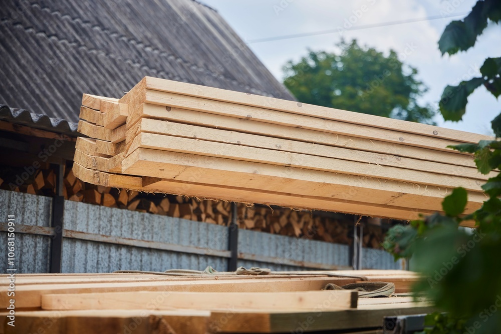Unloading of wood. Sawn boards. Building material in the industry Unloading of wood. Sawn boards. Building material in the industry