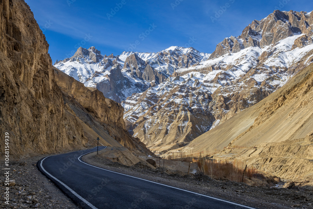 Beautiful mountain road leading to Zanskar Valley in Ladakh, India, surrounded by rugged terrain and snowy peaks Beautiful mountain road leading to Zanskar Valley in Ladakh, India, surrounded by rugged terrain and snowy peaks