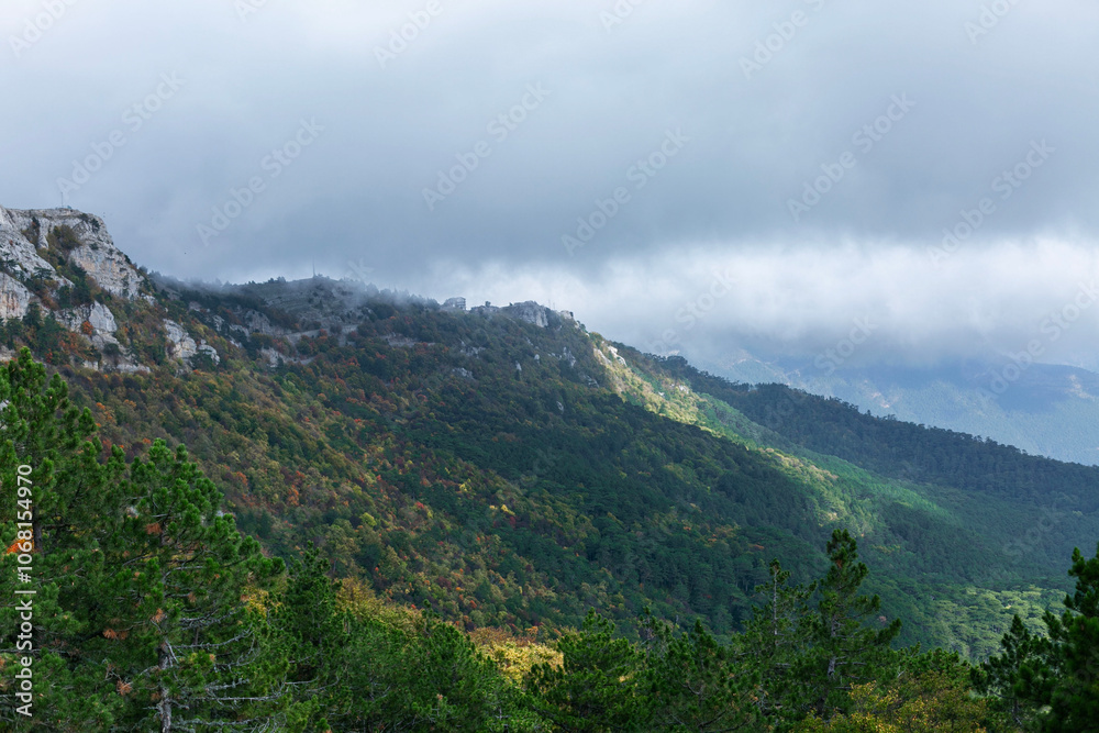 Beautiful view from above on the mountains and dense autumn forest. Tourism and travel. Beautiful view from above on the mountains and dense autumn forest. Tourism and travel.