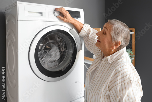Senior woman with washing m...