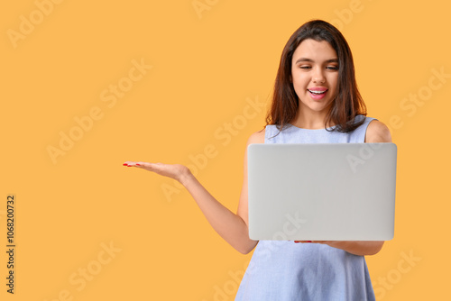 Young woman with laptop sho...