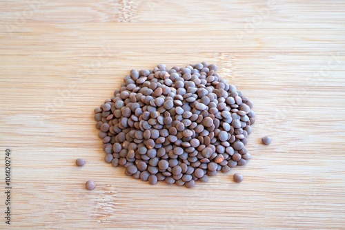 legumes. pile of lentils on a wooden surface.