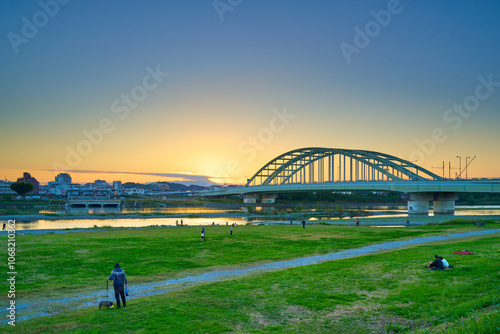 秋の夕方の東京都狛江市の多摩川河川敷から多摩水道橋と川崎市多摩区方面を見る photo