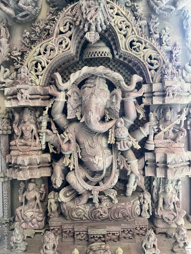 Intricate stone carving of Lord Ganesha in a temple, showcasing detailed craftsmanship Intricate stone carving of Lord Ganesha in a temple, showcasing detailed craftsmanship