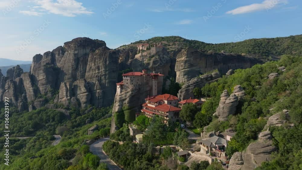 Aerial views highlight the Rousanou Monastery, dramatically situated on a steep rock formation in the stunning Meteora region of Greece Aerial views highlight the Rousanou Monastery, dramatically situated on a steep rock formation in the stunning Meteora region of Greece