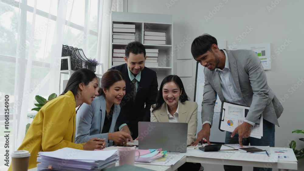 A team of office workers works, meets, discusses and is celebrating a financial business success. Show signs of joy, clapping, and cheerfulness in working together. Success concept. A team of office workers works, meets, discusses and is celebrating a financial business success. Show signs of joy, clapping, and cheerfulness in working together. Success concept.