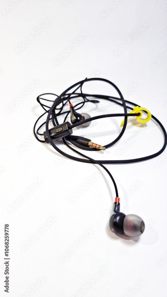 Isolated of earphones on a white background. Use to hear voice, music, video. Used for electronic devices such as cell phones, tablets or other devices. Isolated of earphones on a white background. Use to hear voice, music, video. Used for electronic devices such as cell phones, tablets or other devices.