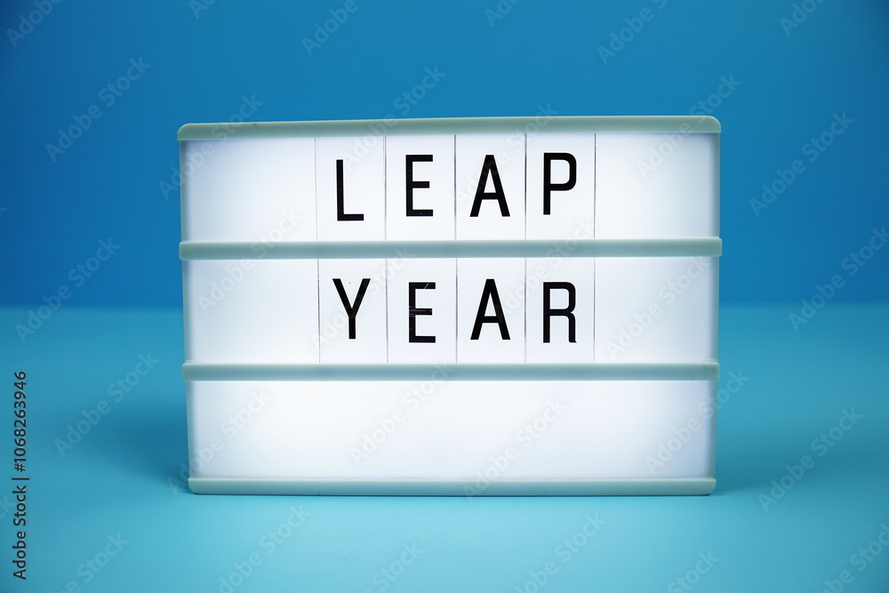 Leap Year letterboard text on LED Lightbox on blue background Leap Year letterboard text on LED Lightbox on blue background