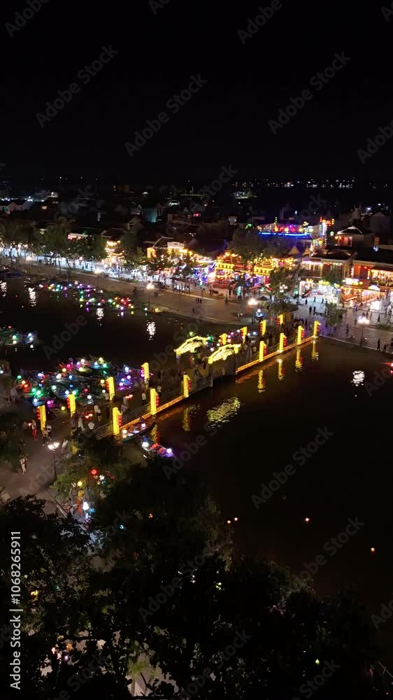 Timelapse or time-lapse of Aerial view of Hoi An old town or Hoian ancient town in evening. Royalty high-quality free stock of Hoai river and boat tour night traffic. One of the most popular touristic