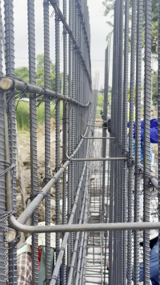 Construction workers are tying rebar to create a retaining wall. Construction workers are tying rebar to create a retaining wall.