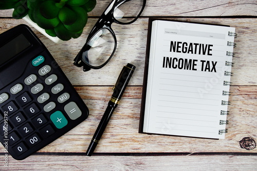 Negative Income Tax (NIT) text on notepad, Business and Financial concept background photo