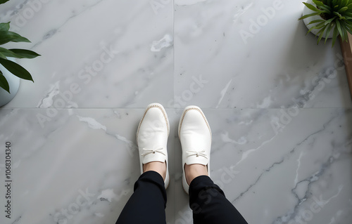 Close-up of stylish white shoes on marble floor in modern indoor setting