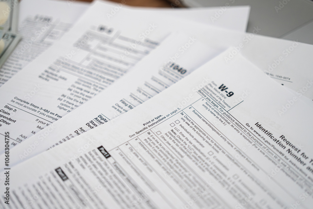 Request for Taxpayer Identification Number and Certification form placed on set of tax forms necessary for taxpayers to ensure accurate reporting of income Request for Taxpayer Identification Number and Certification form placed on set of tax forms necessary for taxpayers to ensure accurate reporting of income