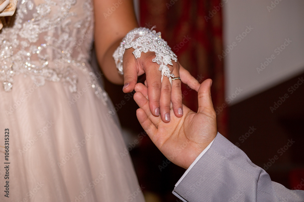 Groom Holding Bride's Hand with Elegant Lace Glove and Wedding Ring - Romantic Moment Closeup Groom Holding Bride's Hand with Elegant Lace Glove and Wedding Ring - Romantic Moment Closeup