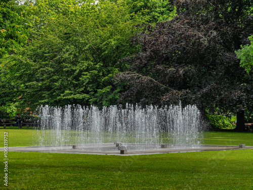 Peaceful Fountain in a Green Park Setting with Lush Trees in Kiel Germany photo