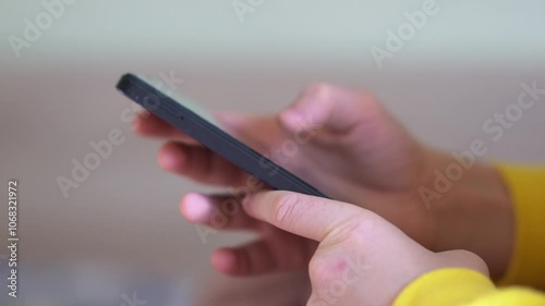 A child uses the keyboard on the phone, types a message, uses an Internet browser