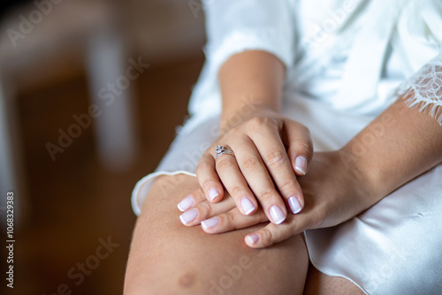 Close-Up of a Bride's Hands with an Engagement Ring, Showcasing Elegant Nails and Wedding Preparation