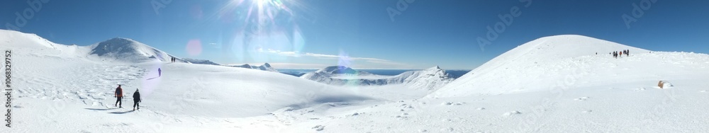 Panoramic snowy mountain landscape with hikers. Panoramic snowy mountain landscape with hikers.