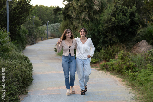 Two girls in a loving couple sharing a tender moment at the park