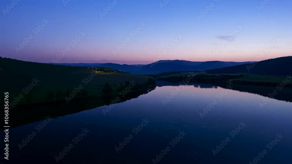Tranquil lake surrounded by rolling hills at dusk, soft twilight, pan camera movement, establishing scene Tranquil lake surrounded by rolling hills at dusk, soft twilight, pan camera movement, establishing scene