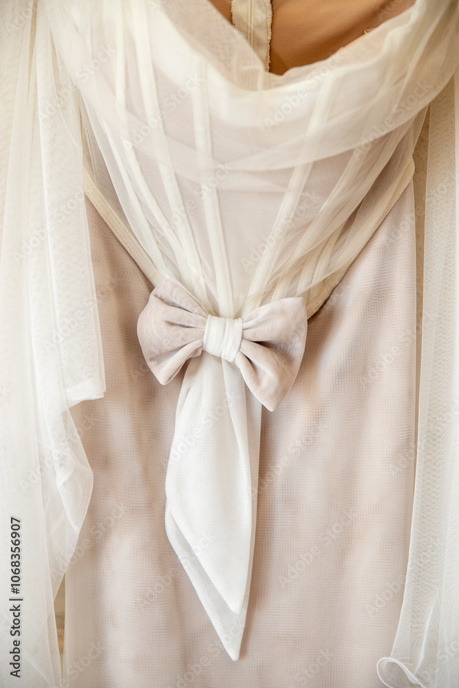 Elegant satin bow detail on a white wedding dress Elegant satin bow detail on a white wedding dress
