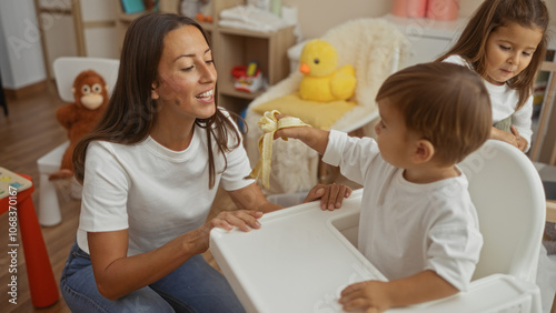 Mother smiling as son offers her a banana in a cozy living room while daughter watches lovingly, showcasing family warmth and connection.