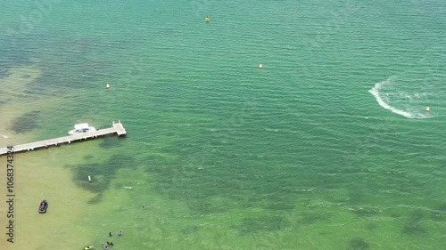 Active summer holidays beachgoers on waterjets in Lake Macquarie Murrays beach.
 photo