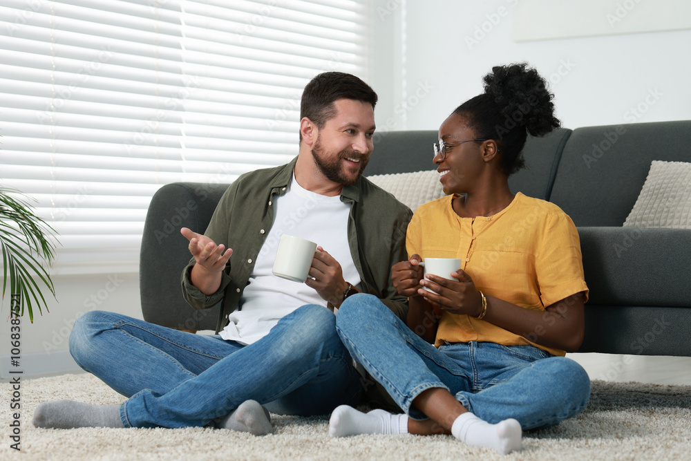 Obraz premium International relationships. Lovely couple spending time together on floor at home