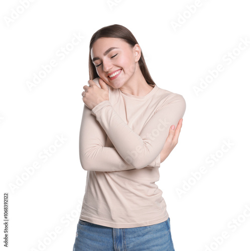 Charming young woman hugging herself on white background