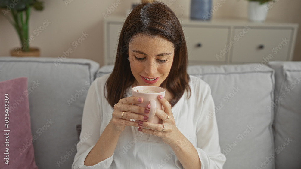 A young hispanic woman enjoys a relaxing moment with a cup of coffee in an urban home interior setting, illustrating comfort and tranquility in a cozy living room ambiance. A young hispanic woman enjoys a relaxing moment with a cup of coffee in an urban home interior setting, illustrating comfort and tranquility in a cozy living room ambiance.