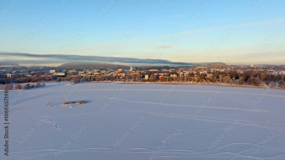 Drone approaching Kuopio city from lake Kallavesi, winter morning in Finland Drone approaching Kuopio city from lake Kallavesi, winter morning in Finland