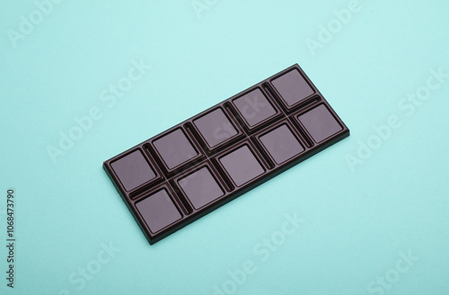 Dark chocolate bar on a blue background photo