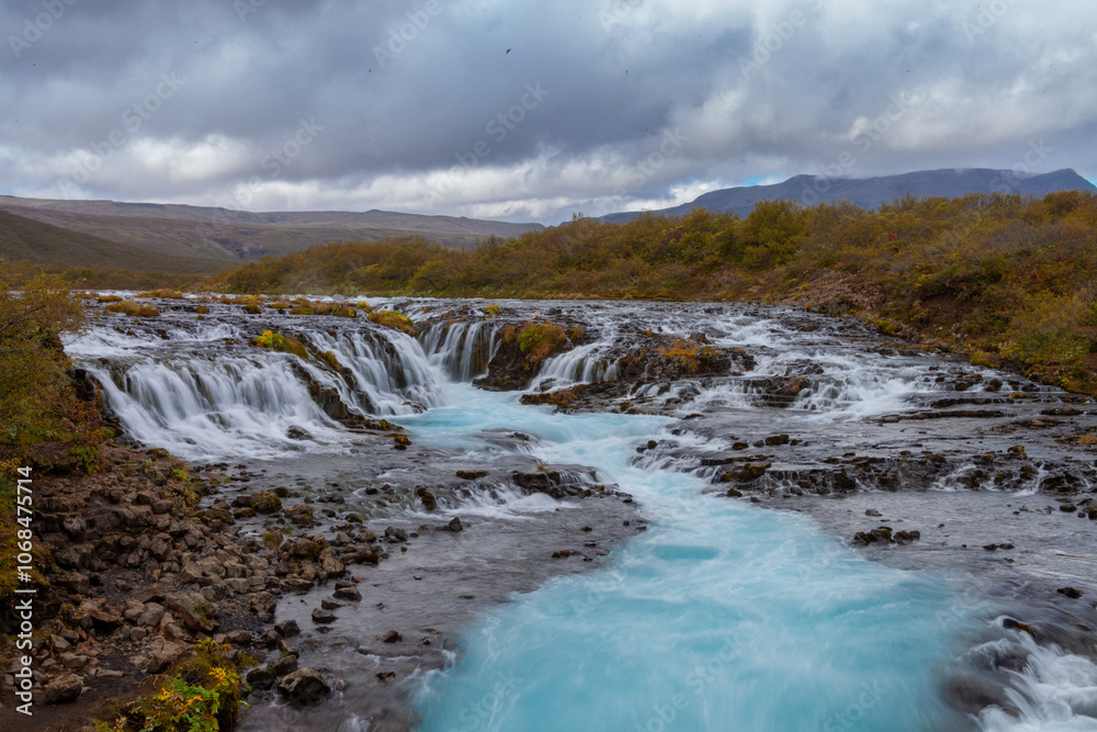 Wide Waterfall in Iceland with Blue Water Wide Waterfall in Iceland with Blue Water