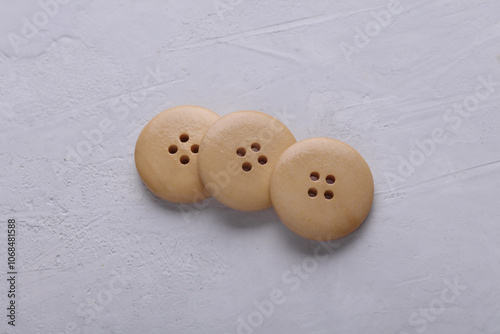 Wooden buttons on a concrete background