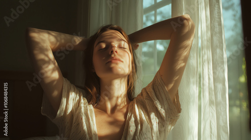 Serene woman basking in morning light by the window