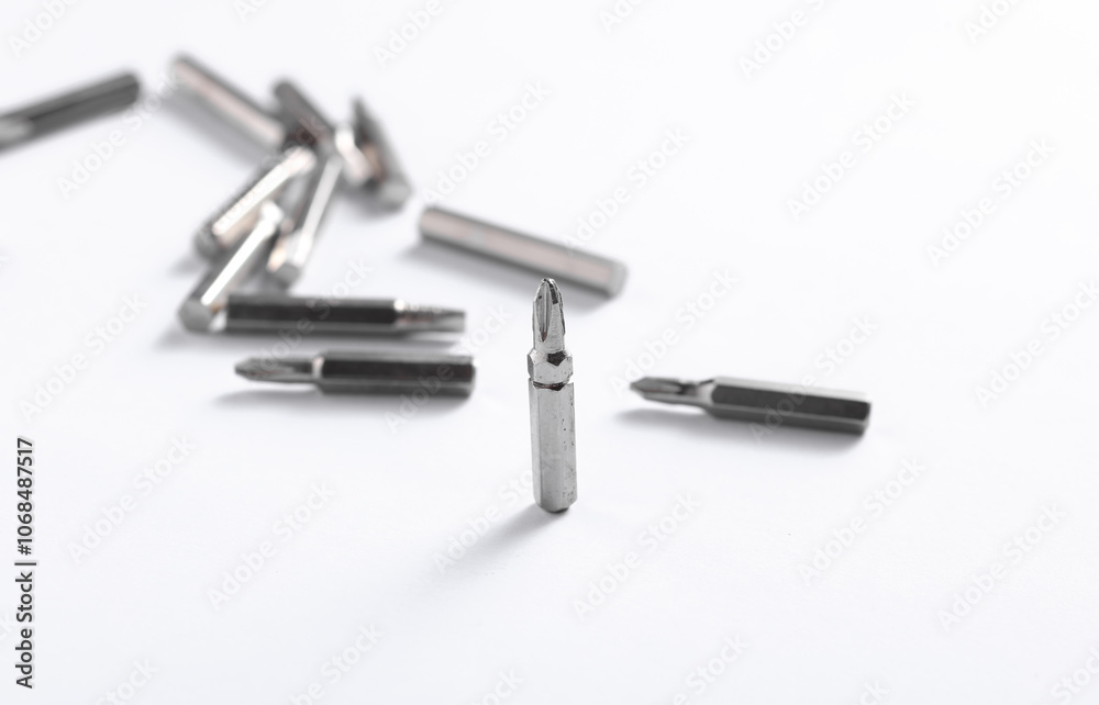 Set of metal screwdriver bits on white background Set of metal screwdriver bits on white background
