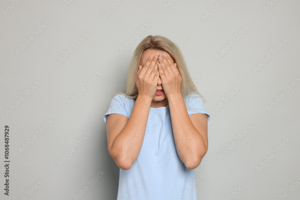 Portrait of scared woman on gray background Portrait of scared woman on gray background