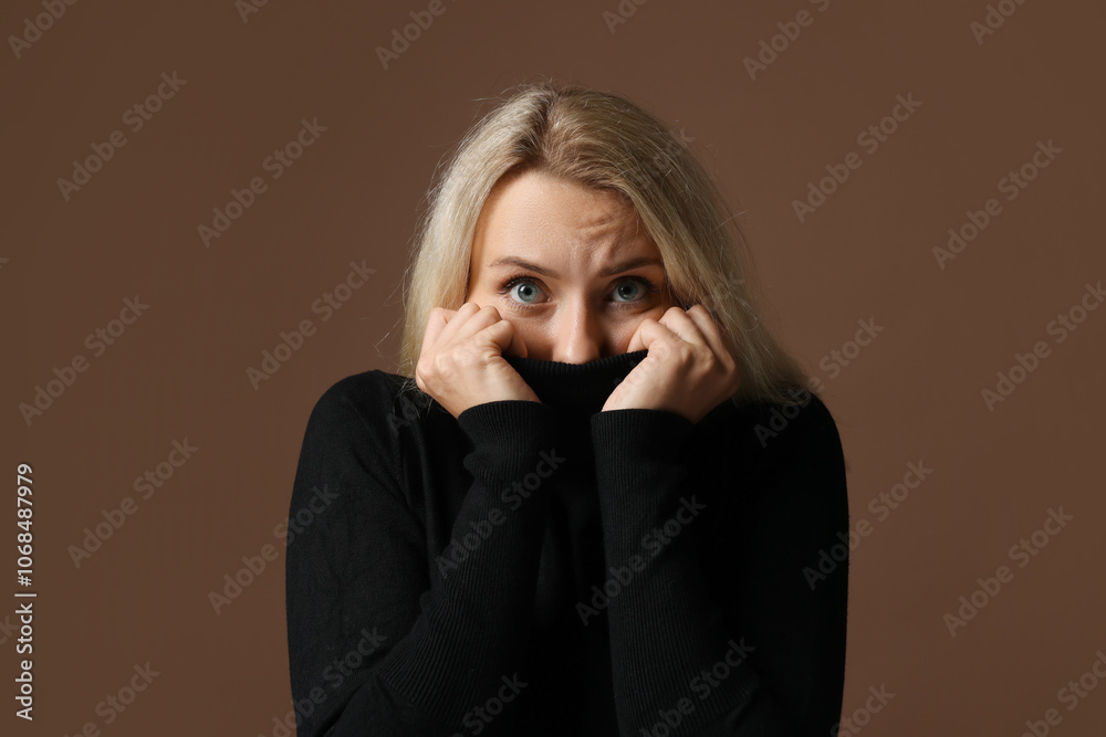 Portrait of scared woman on brown background Portrait of scared woman on brown background